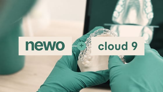 Newo and Cloud 9 integration over gloved hands holding a clear aligner on a dental model.