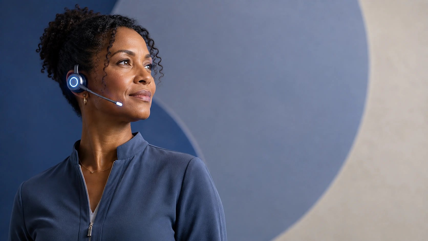 A studio studio professional wearing a Newo communications earpiece, listening on a call