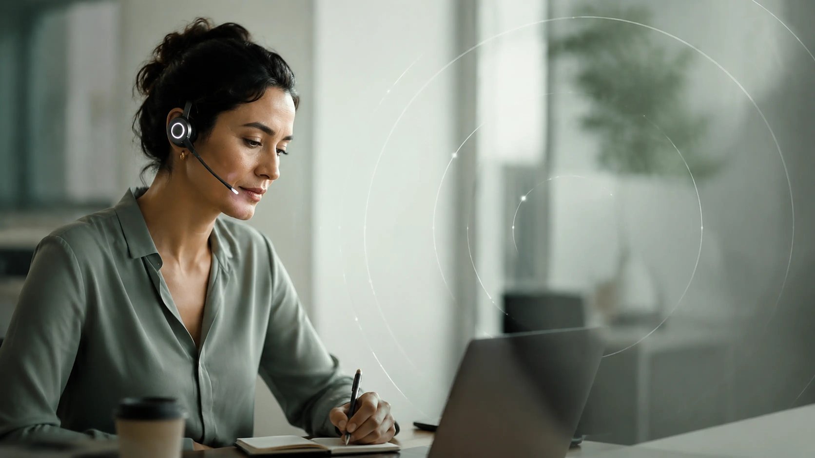 A team member wearing a Newo headset, taking an inbound call at her desk