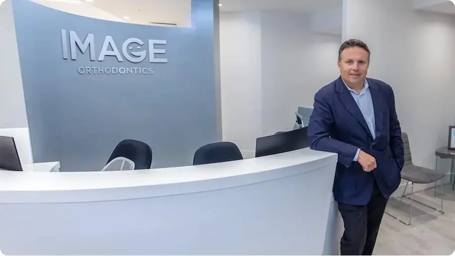 Dr. Yan Kalika at the front desk of Image Orthodontics